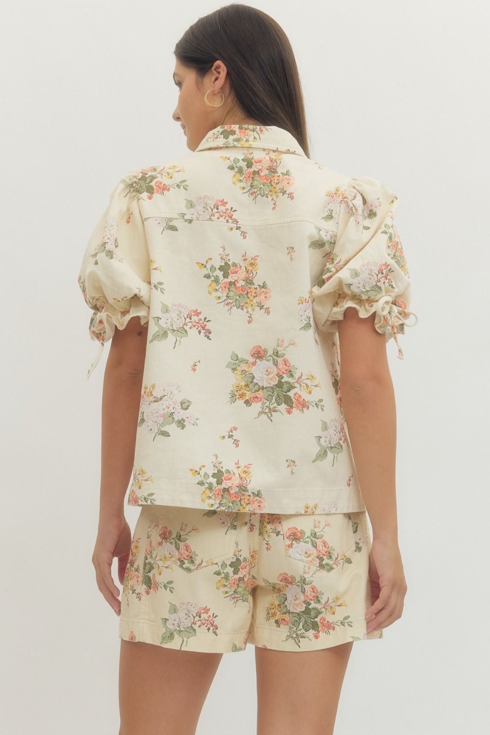 Woman wearing a floral pajama set on a white background