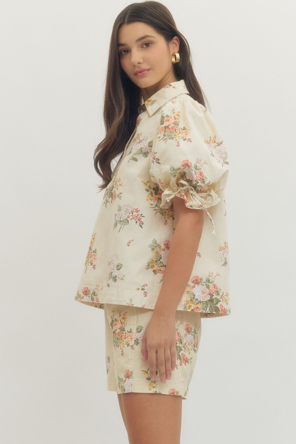 Woman wearing a floral outfit on a white background