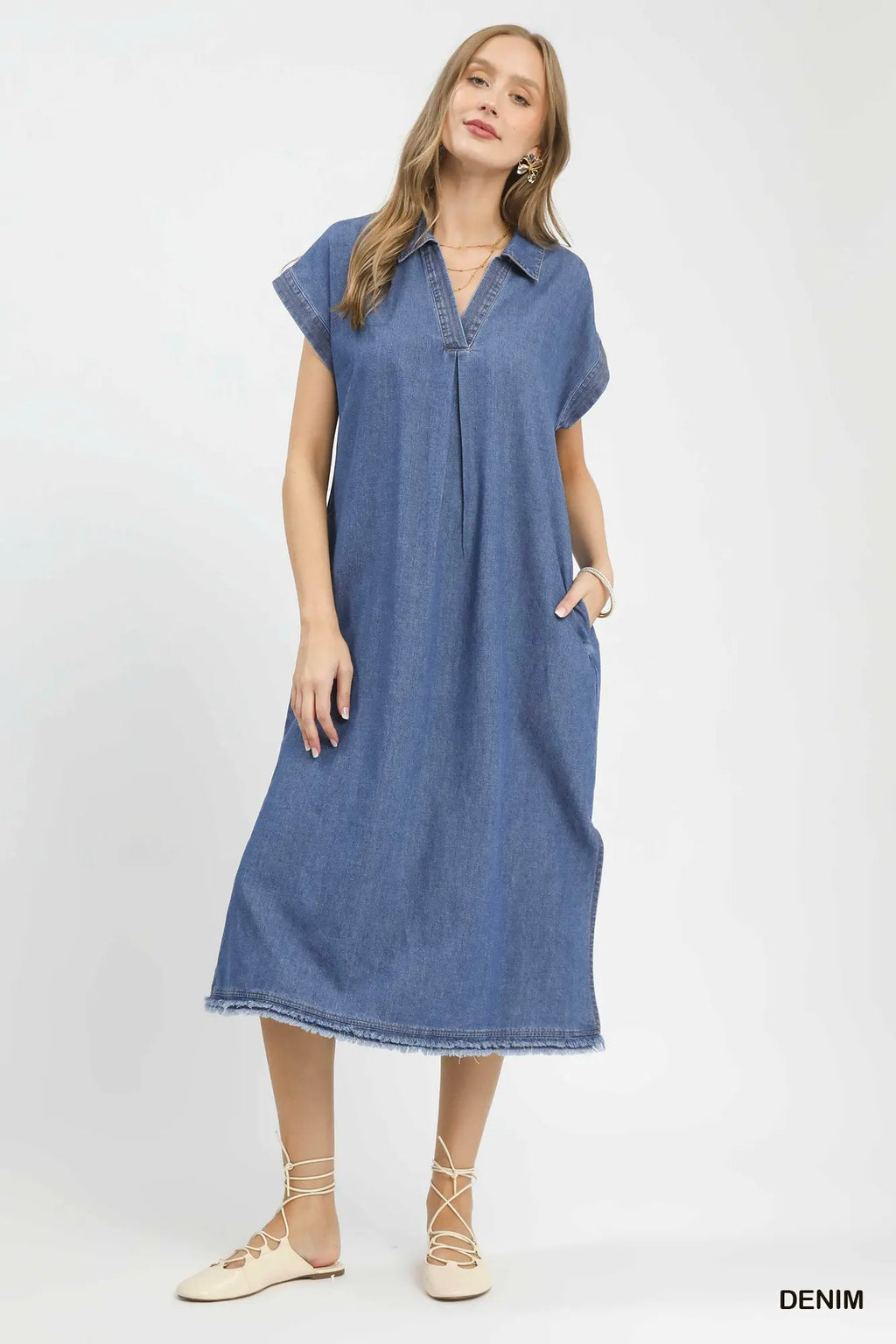 Woman wearing a denim dress on a white background