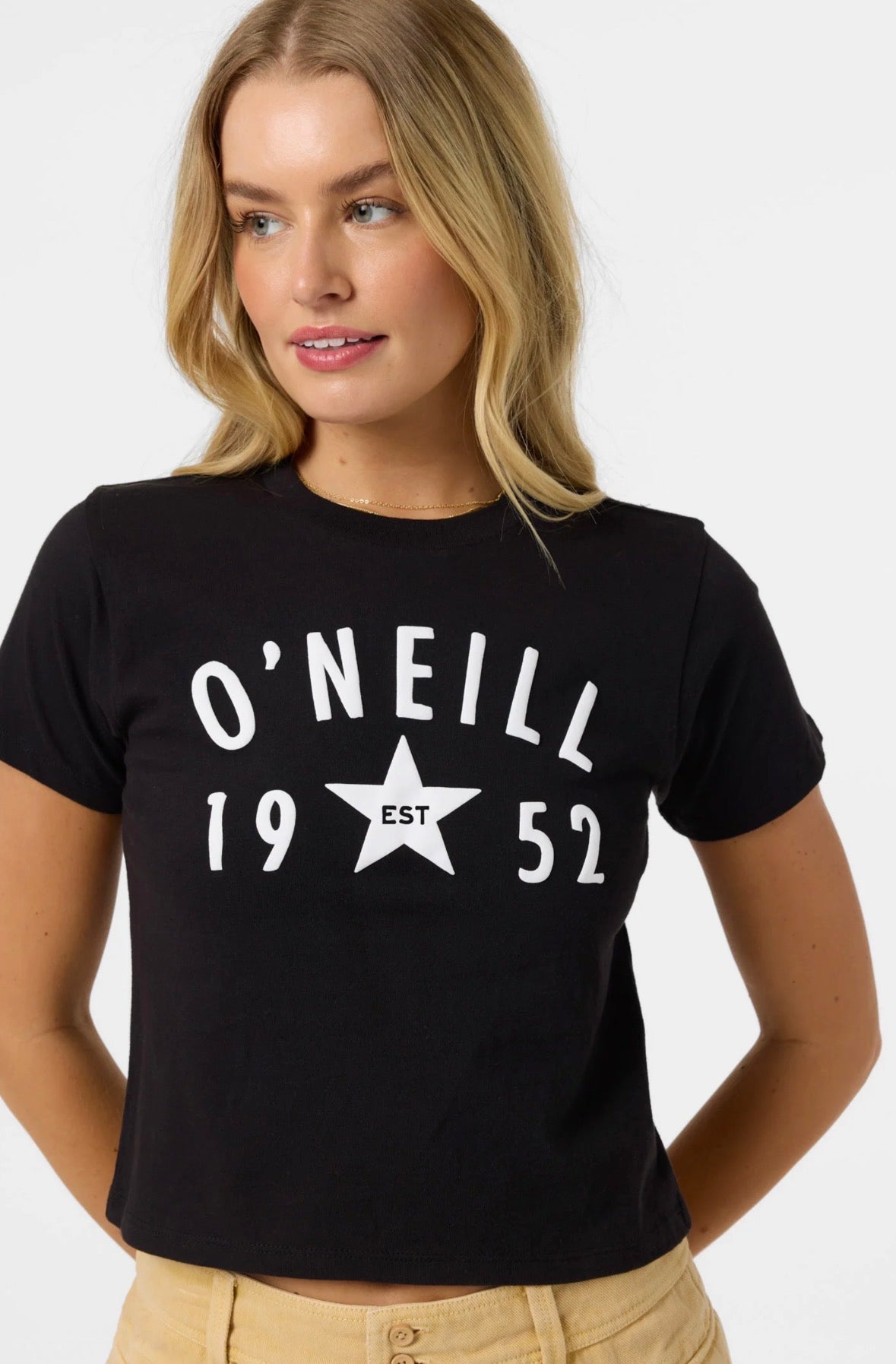 Woman wearing a black O'Neill t-shirt with a star and text design on a white background