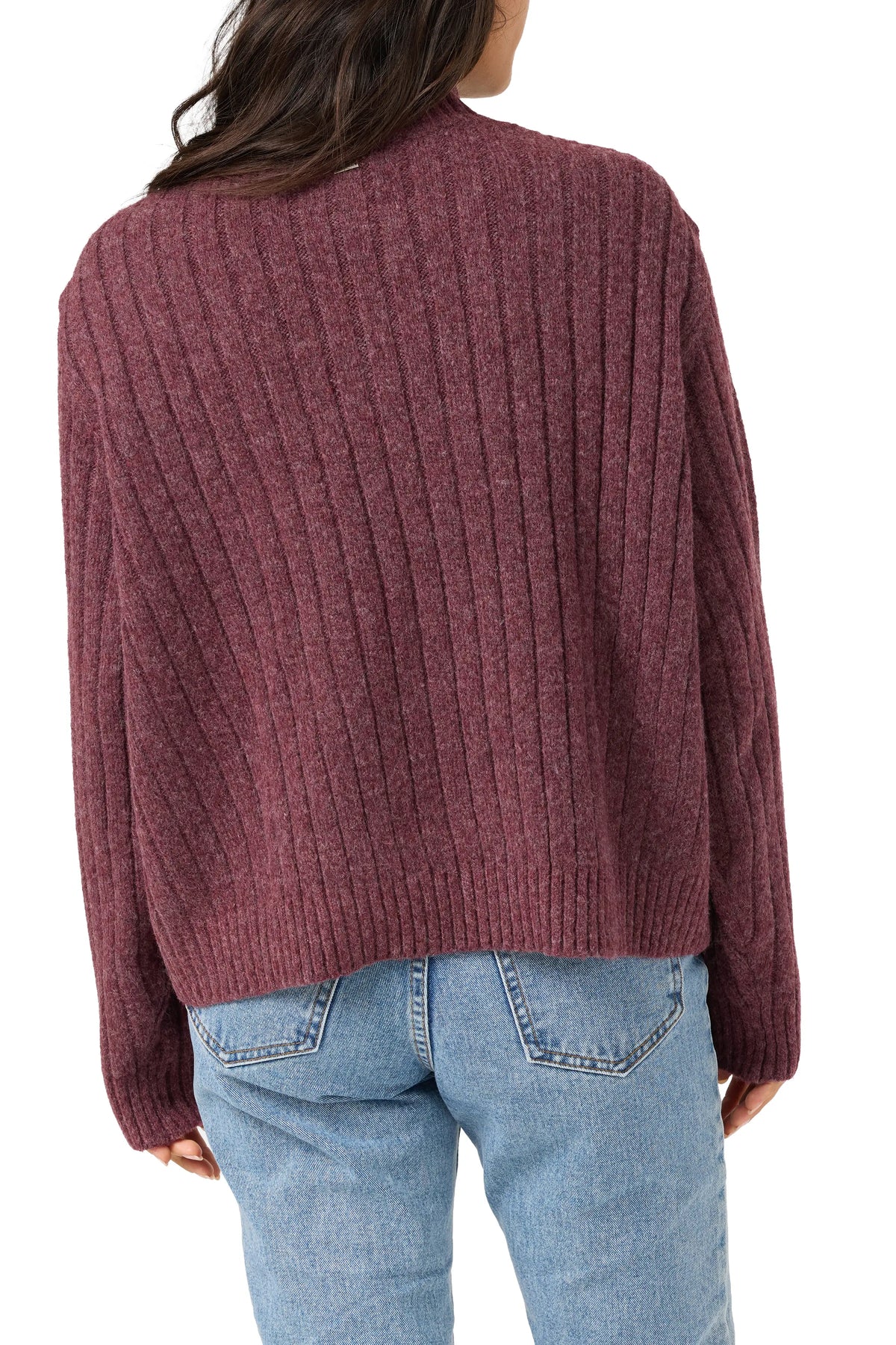A person shown from the back wearing a ribbed knit sweater in a muted burgundy or plum tone, paired with light blue jeans, against a plain white background.
