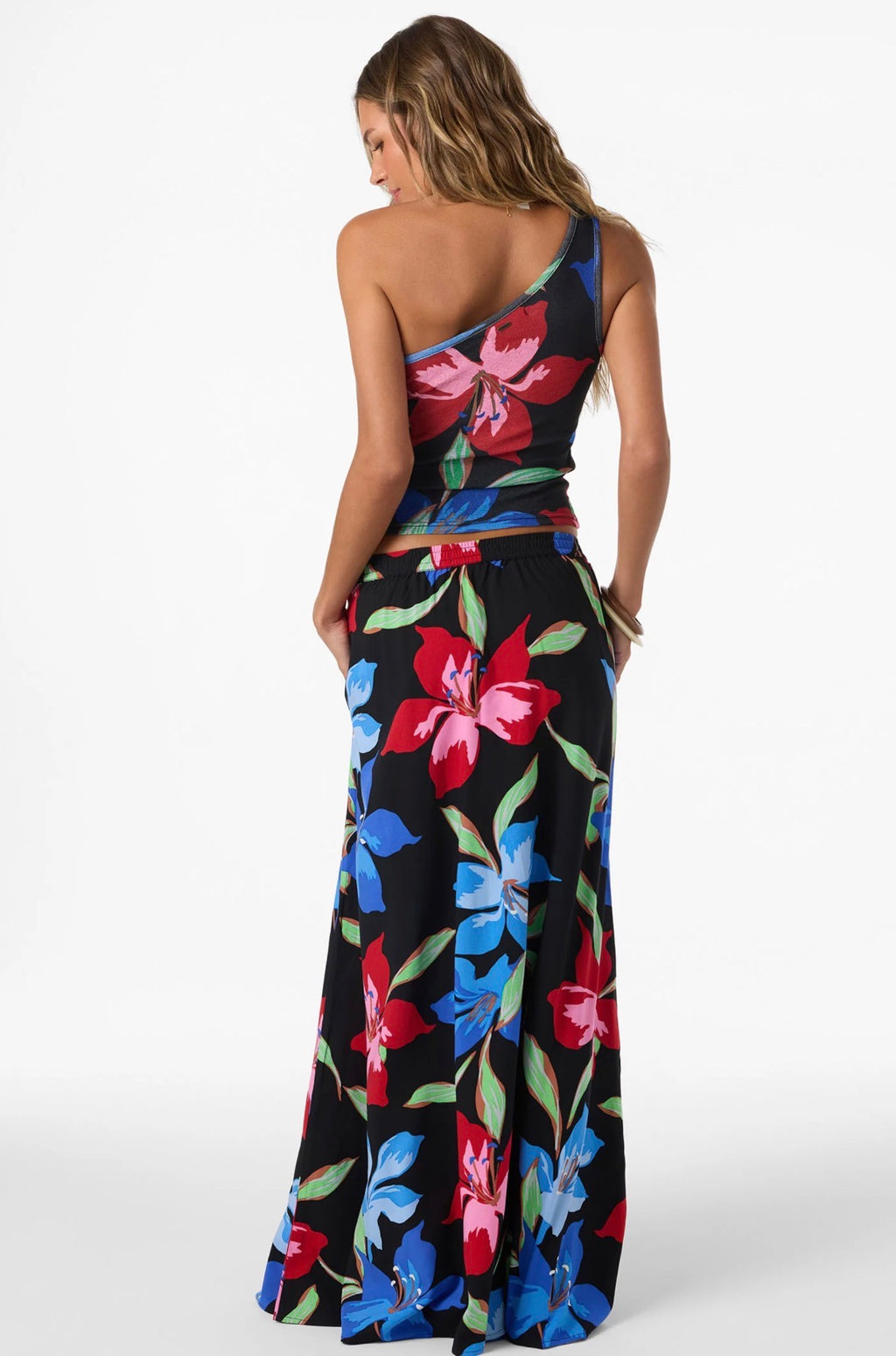 Woman wearing a colorful floral dress on a white background