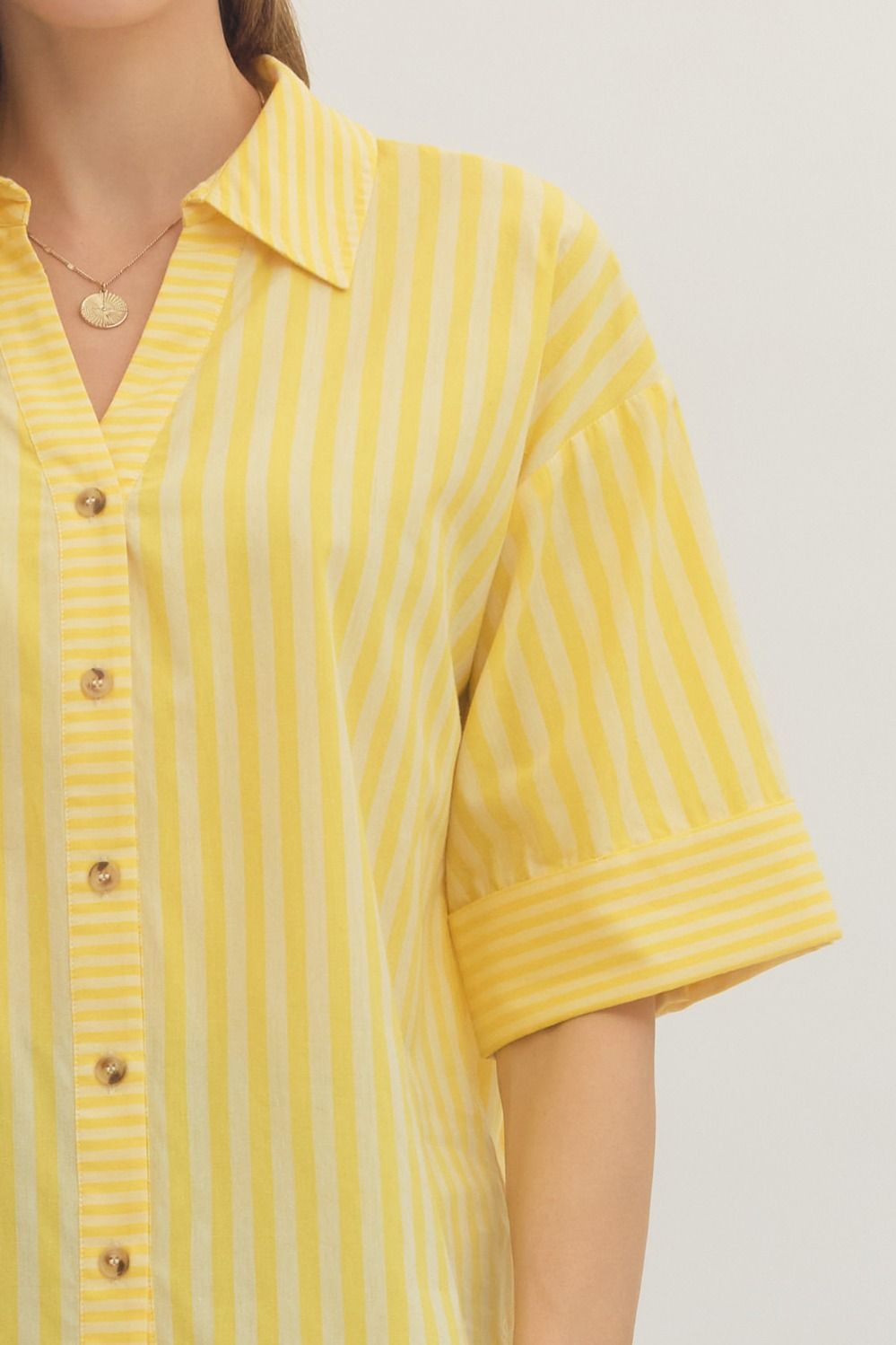 Yellow striped shirt worn by a person, with a focus on the upper body.
