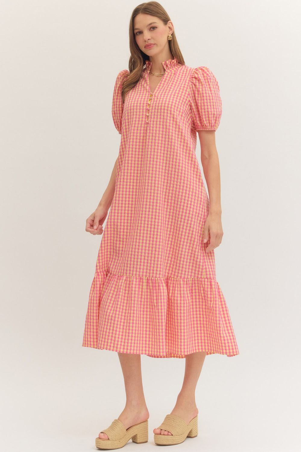 Woman wearing a red and white checkered dress on a white background