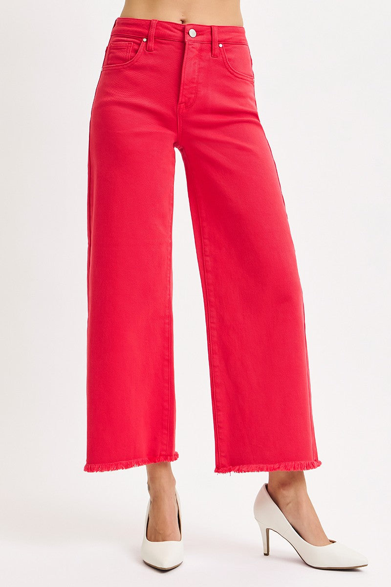 Red jeans worn by a person on a white background