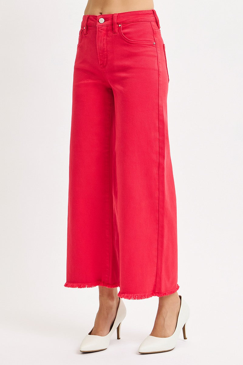 Red wide-leg jeans worn by a person on a white background