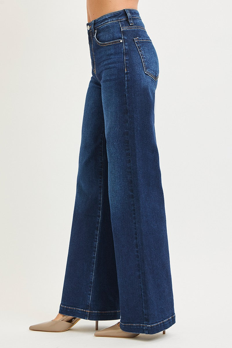 Blue jeans worn by a person on a white background