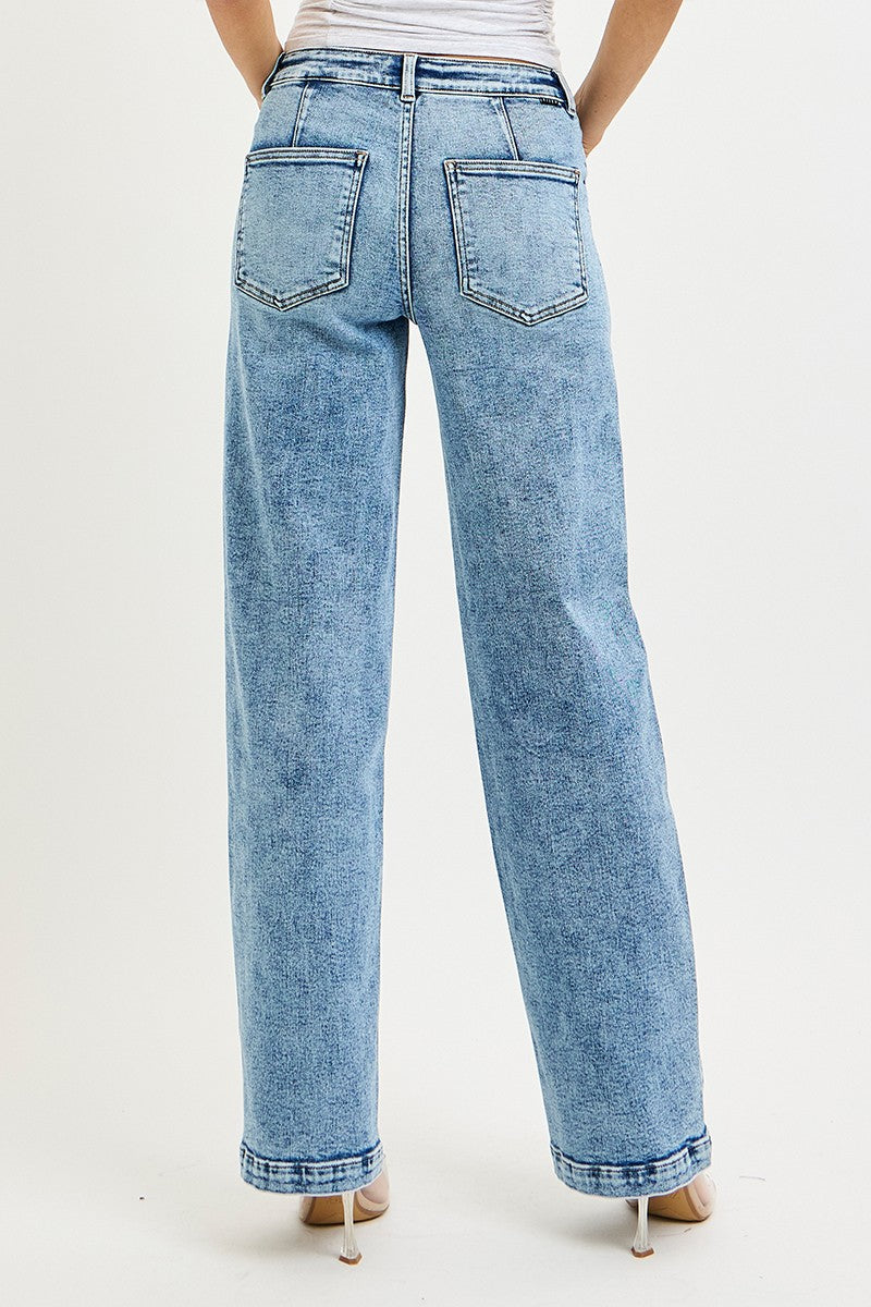Light blue jeans worn by a person on a white background