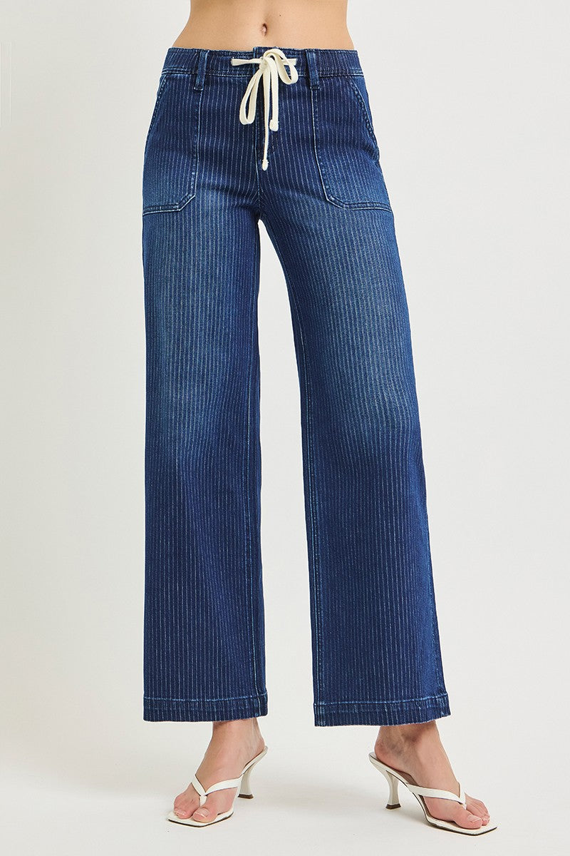 Blue jeans with a drawstring waist on a white background