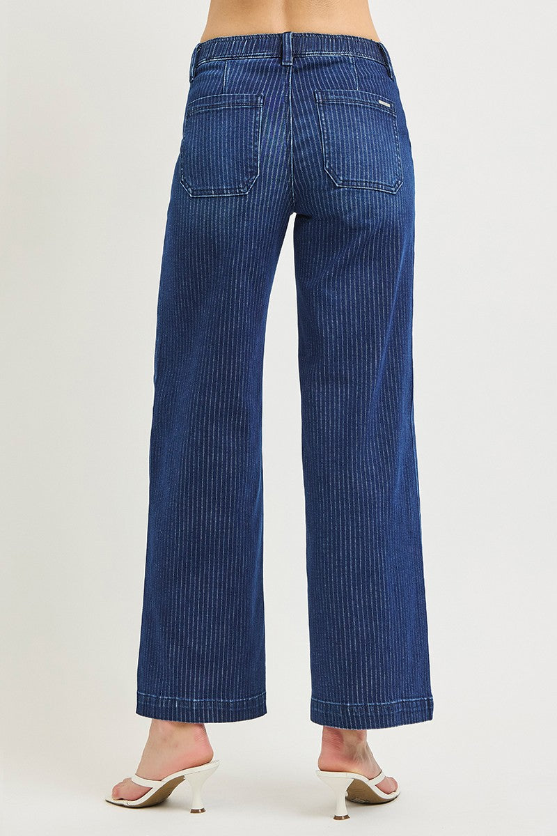 Blue jeans worn by a person on a white background