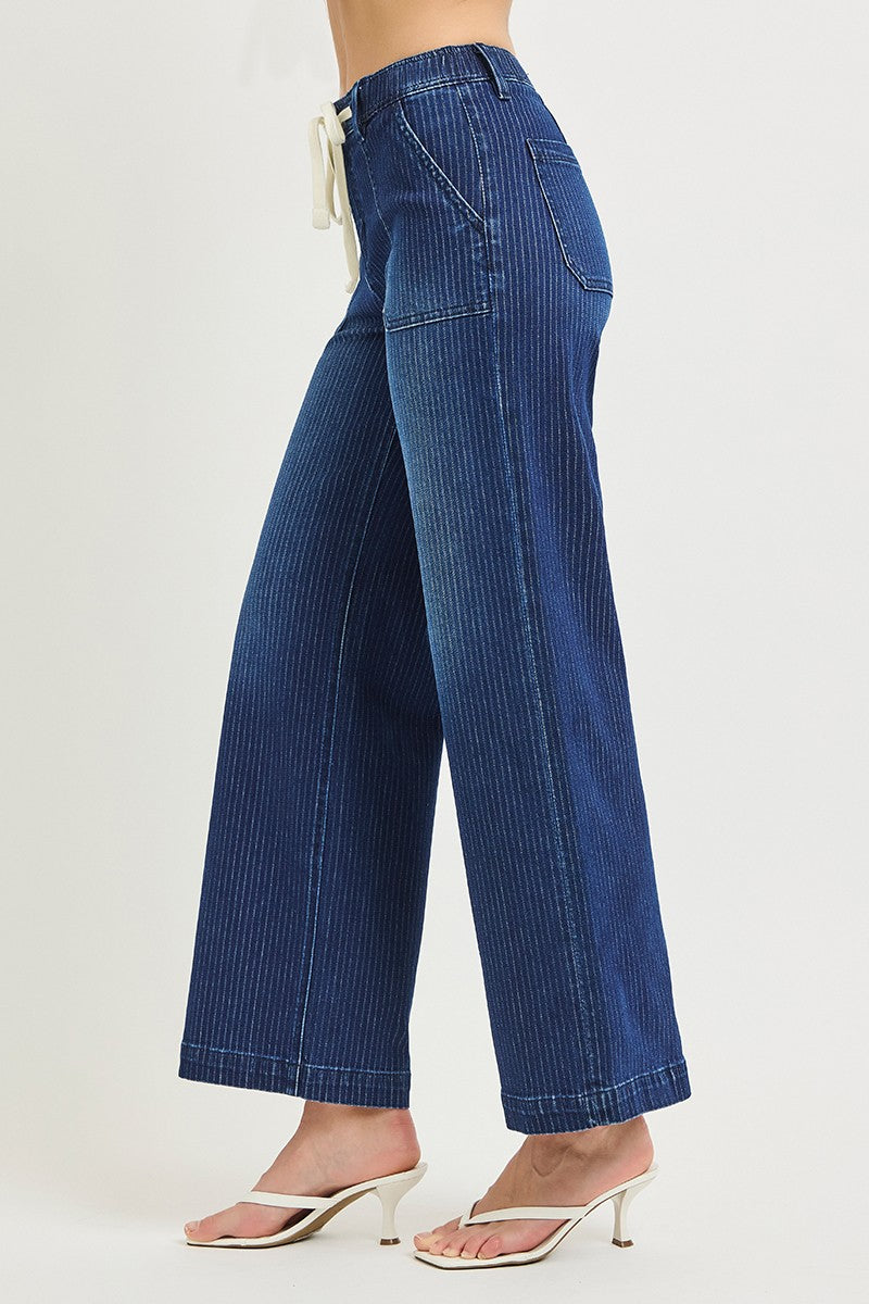 Blue striped pants worn by a person on a white background