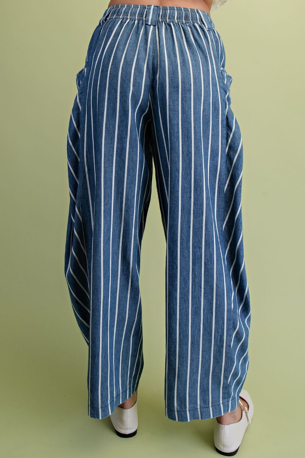 Blue and white striped pants on a green background