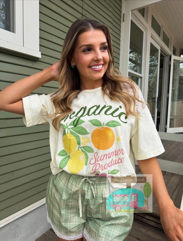 Woman wearing a 'Organic Summer Produce' t-shirt on a porch