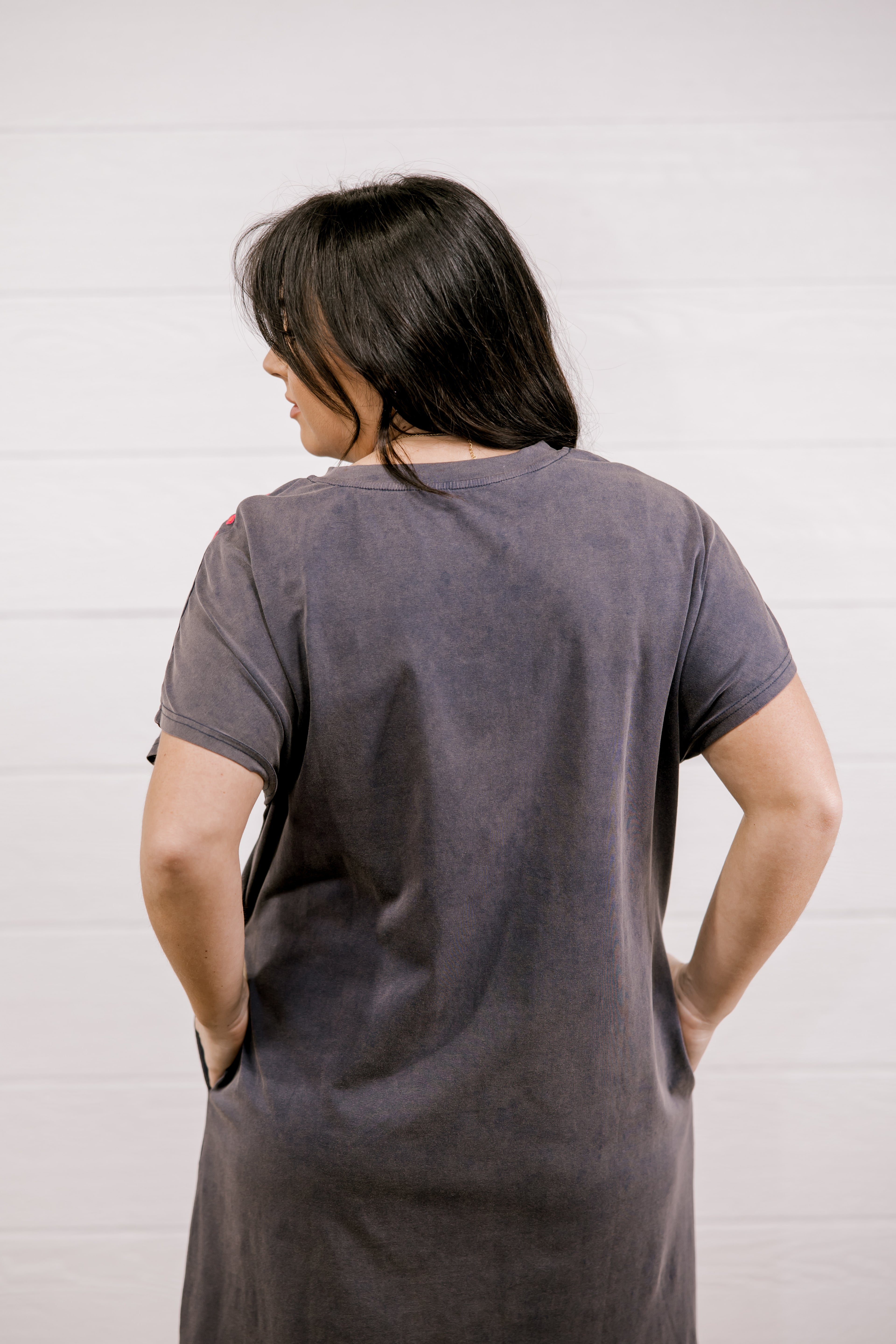 Person wearing a gray t-shirt against a white background