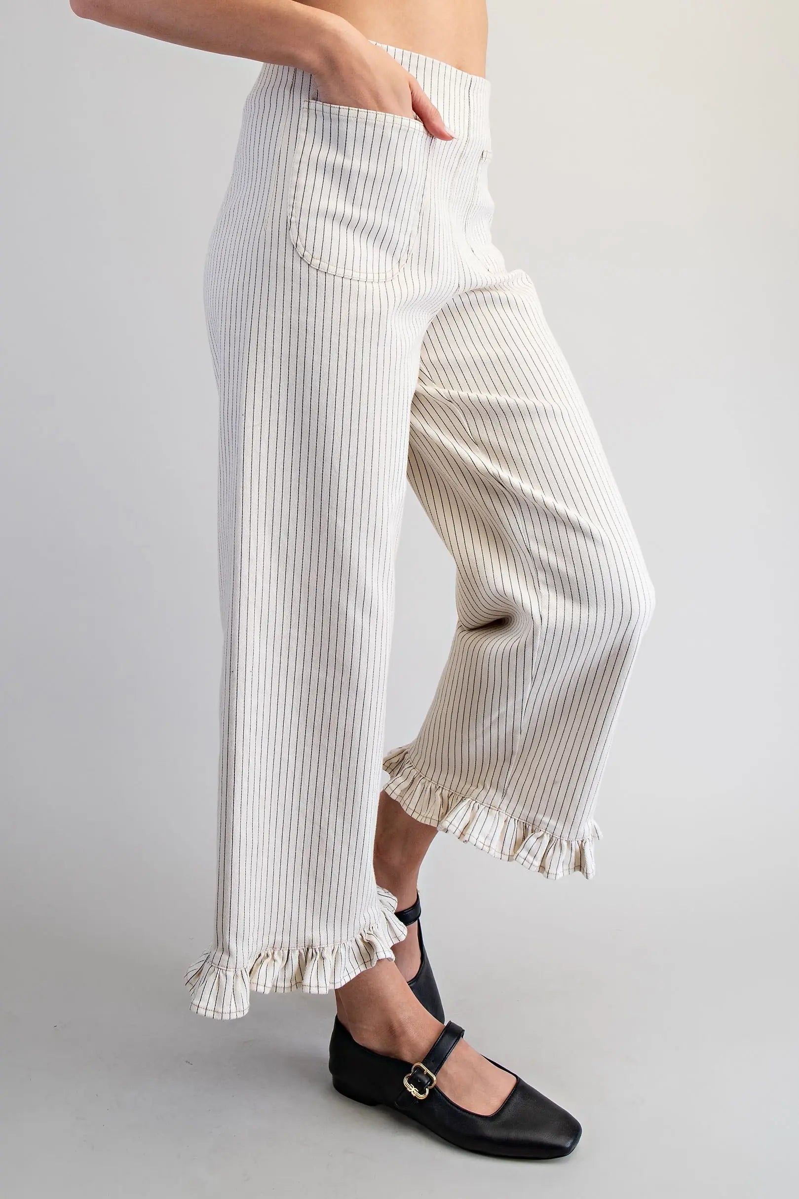 Striped pants with ruffle hem on a plain background