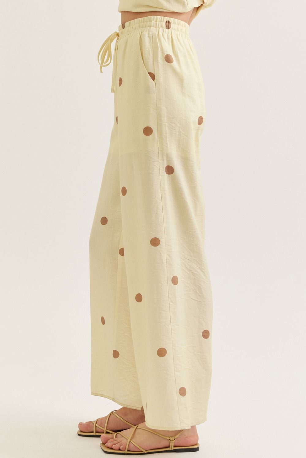 Beige pants with brown polka dots on a white background