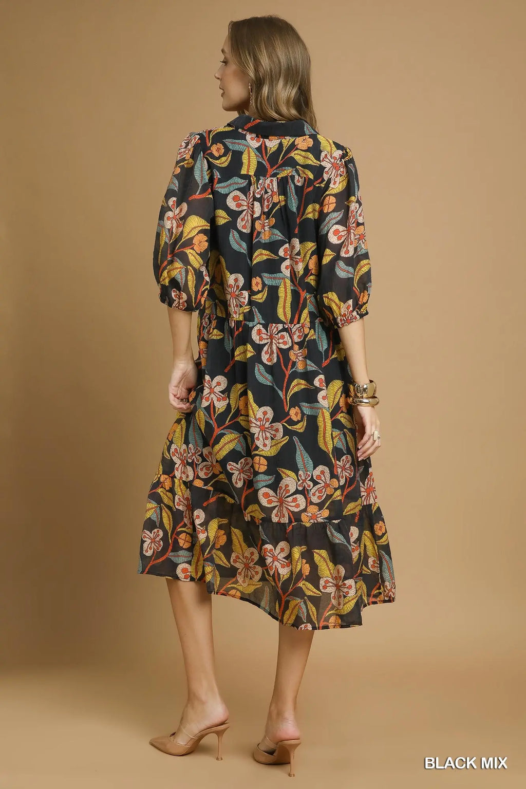 Woman wearing a floral dress against a beige background