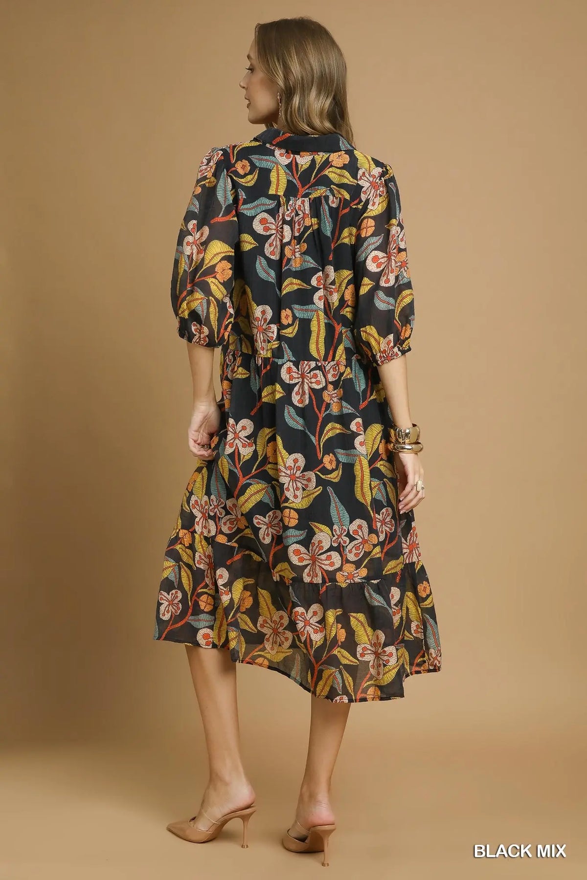 Woman wearing a floral dress against a beige background