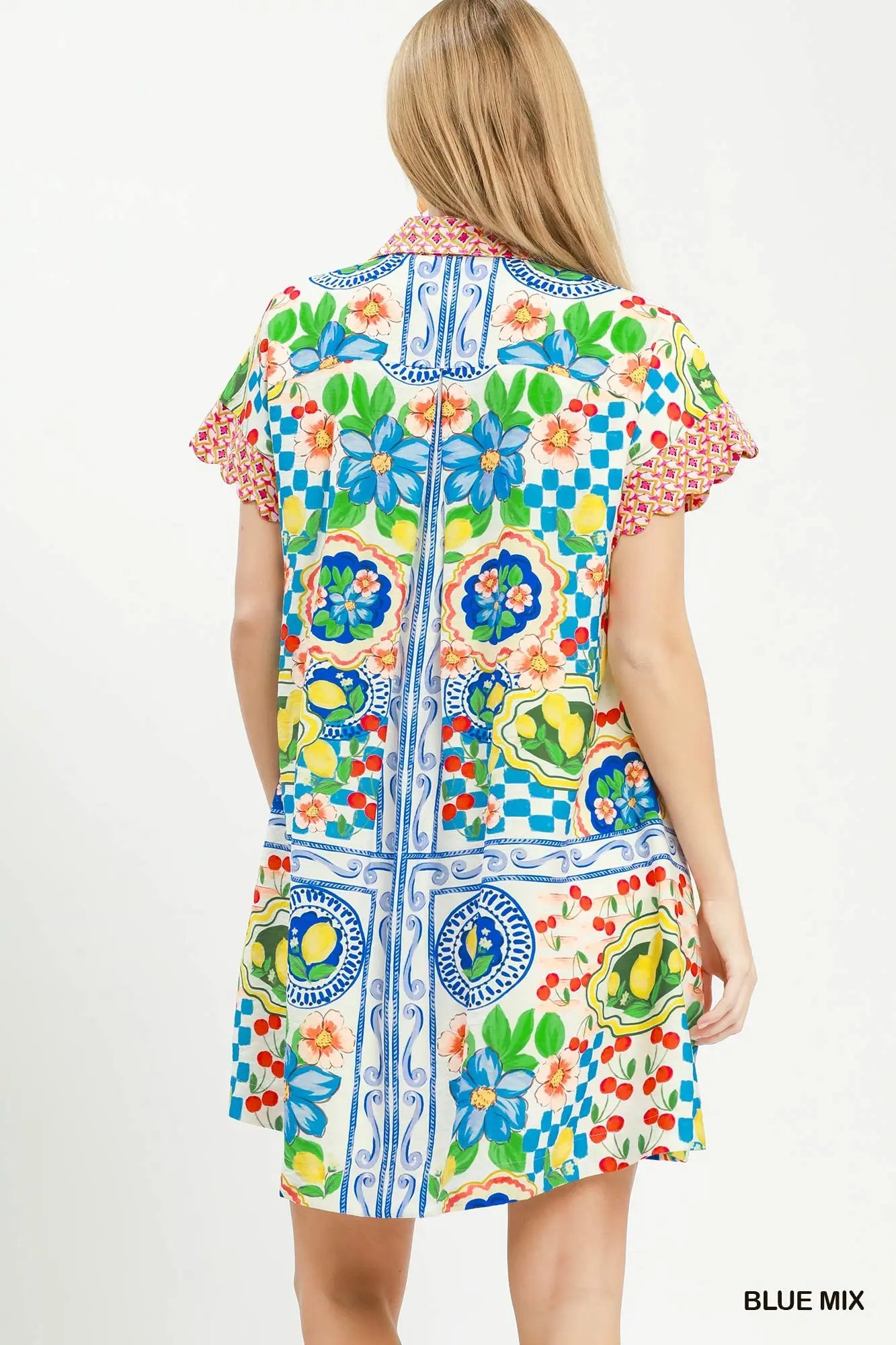 Woman wearing a colorful patterned dress on a white background