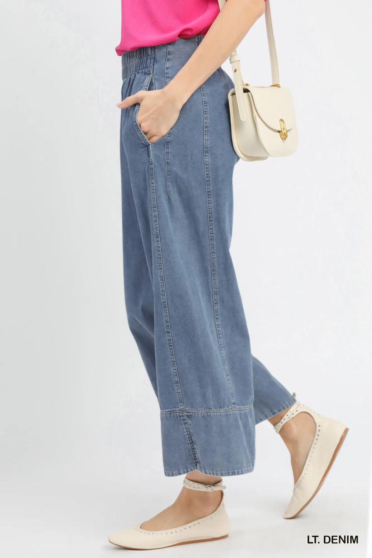 Light denim pants worn by a person on a light gray background