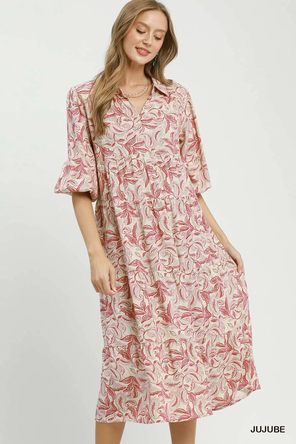 Woman wearing a pink floral dress on a white background