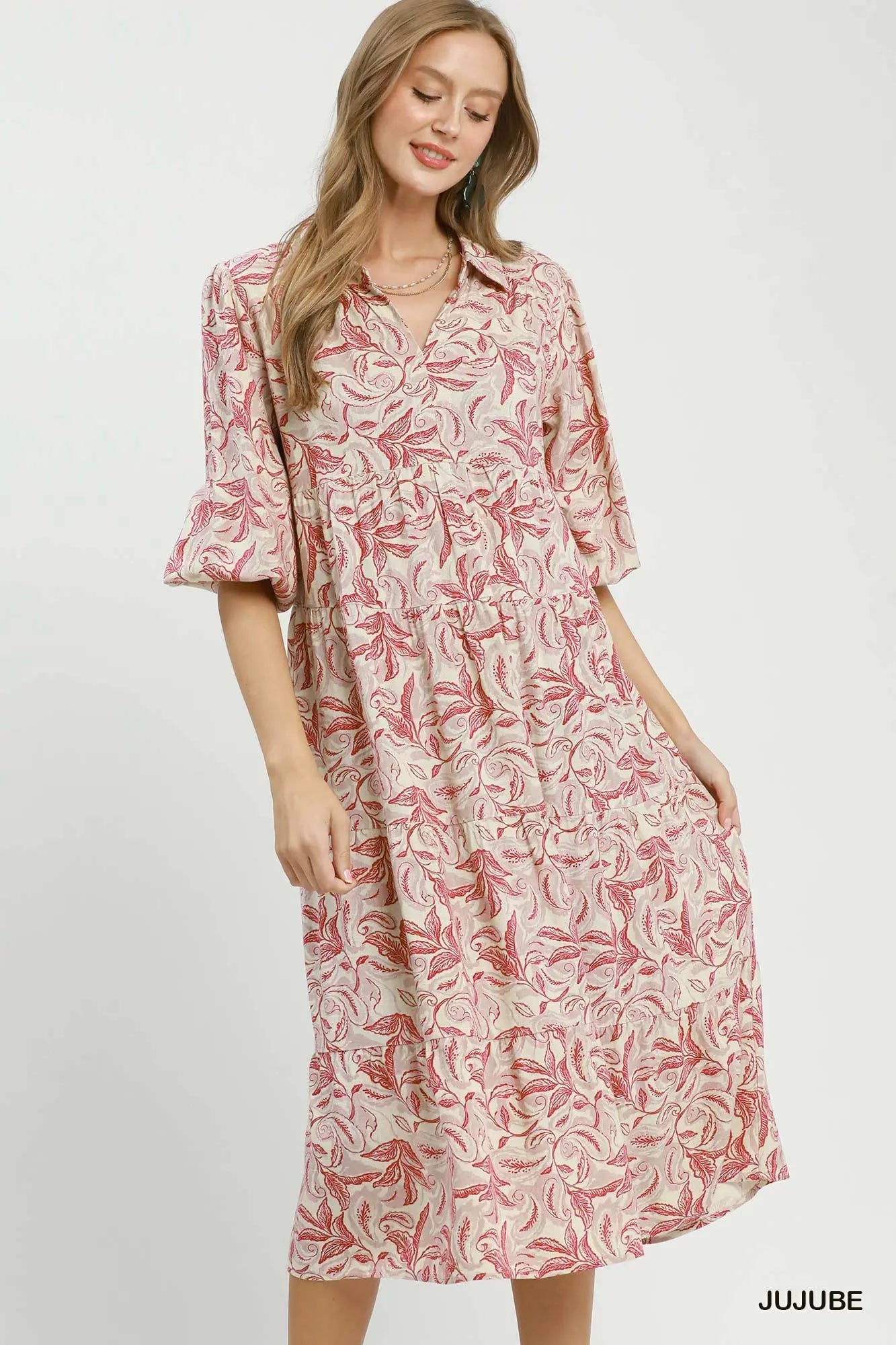 Woman wearing a pink floral dress on a white background