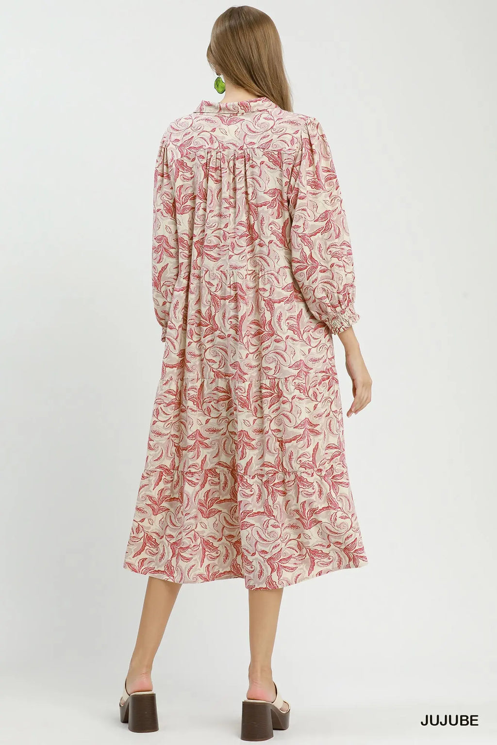 Woman wearing a floral dress on a white background with 'JUJUBE' branding.
