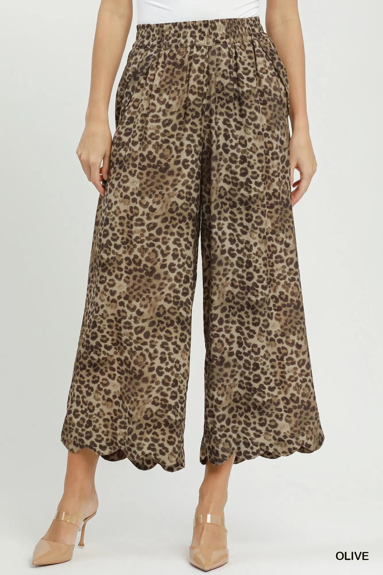 Leopard print pants worn by a person on a white background