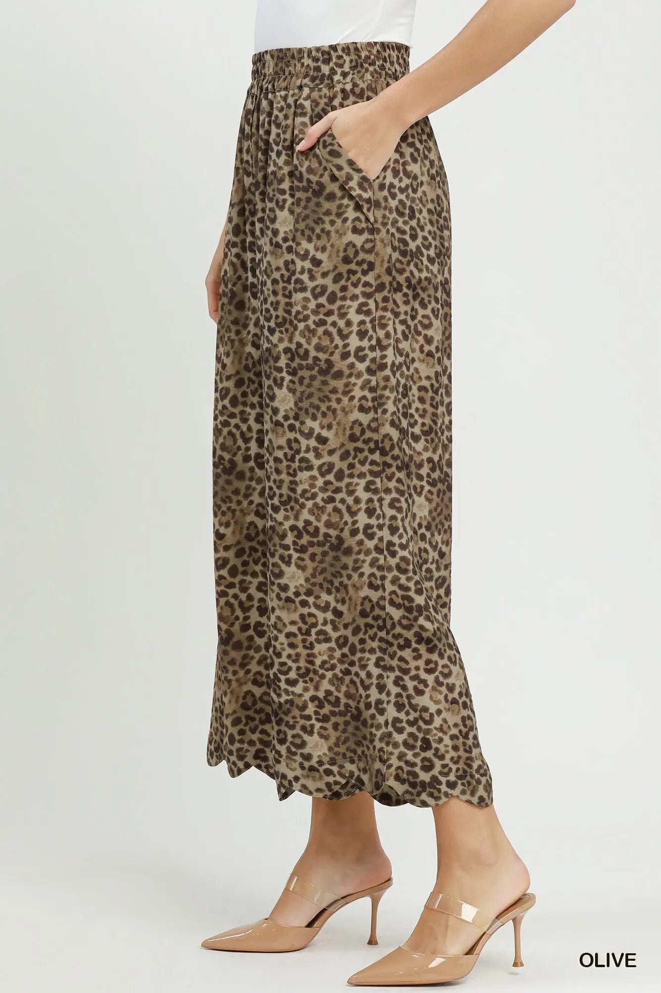 Leopard print skirt worn by a person on a white background