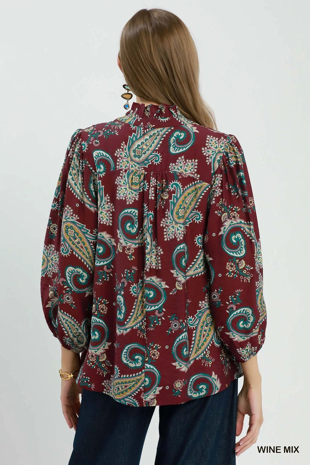 Woman wearing a patterned blouse with a white background