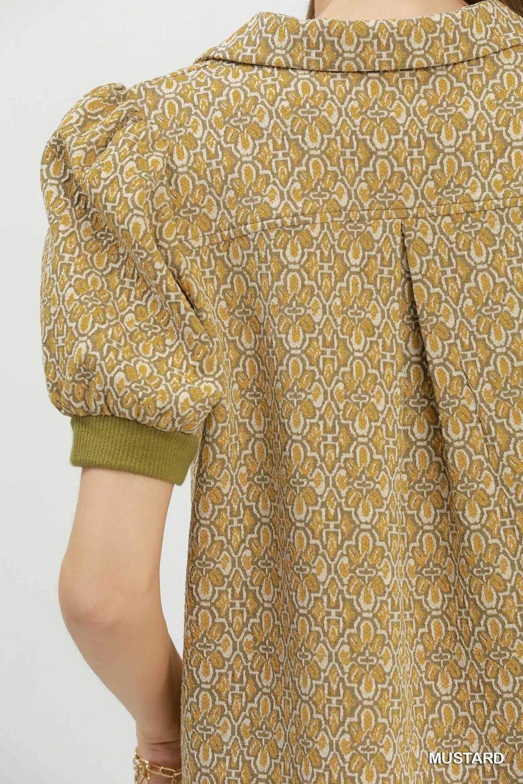 Patterned mustard yellow dress with puff sleeves on a white background