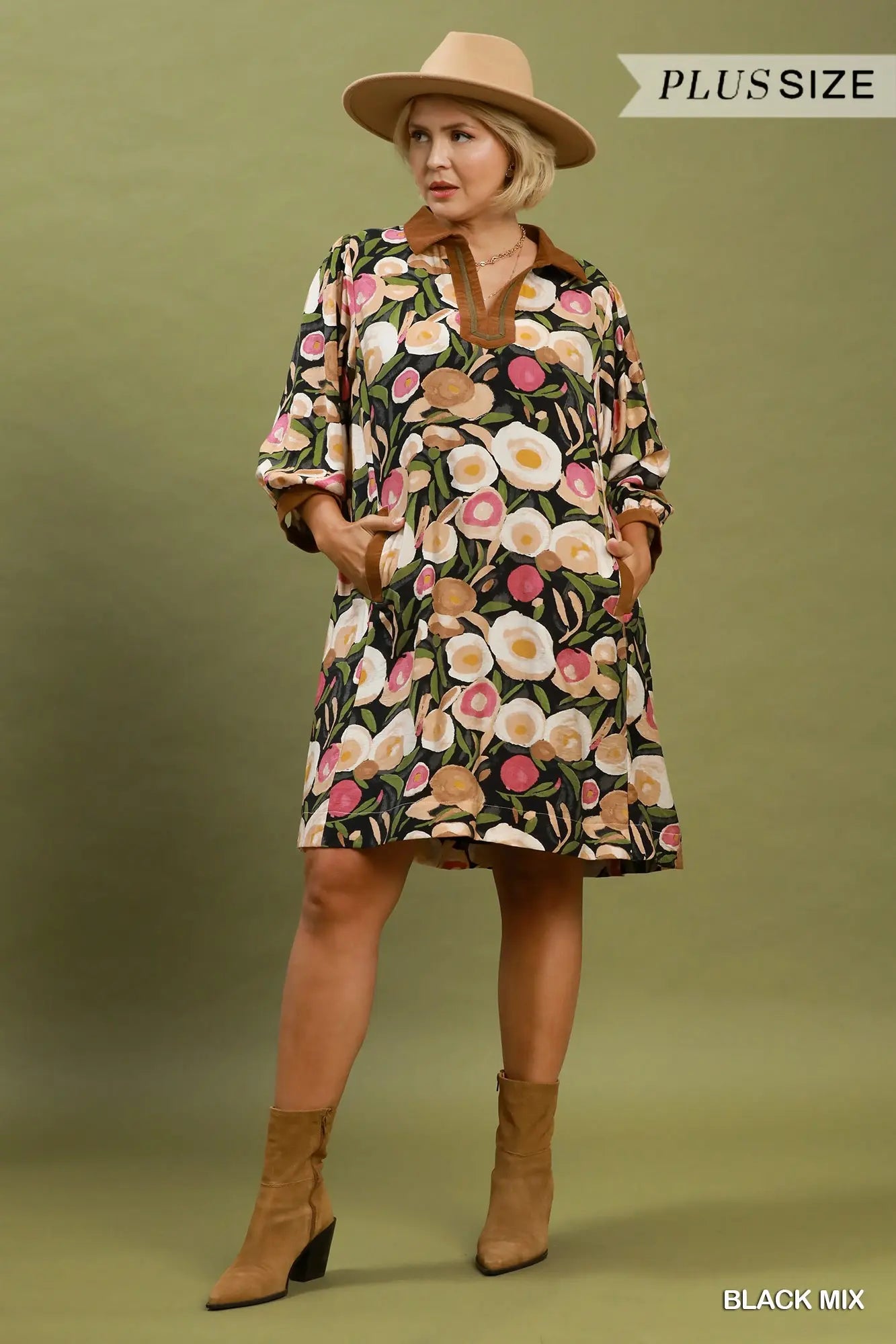 Woman wearing a floral dress with a hat on a green background