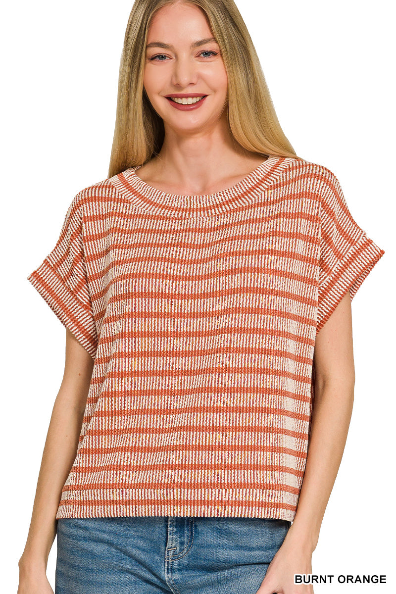 Woman wearing a striped shirt with 'Burnt Orange' label on a white background
