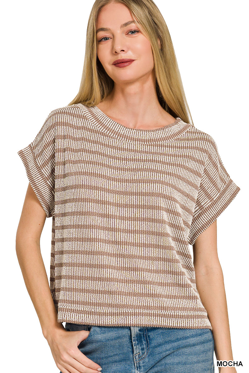 Woman wearing a striped shirt with a plain background