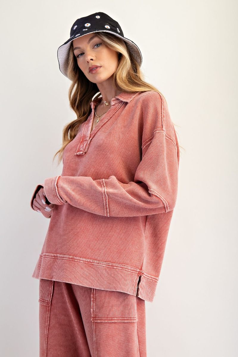 Woman wearing a pink outfit with a polka dot hat on a white background