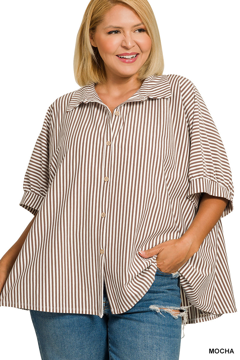 Woman wearing a striped shirt with a plain background