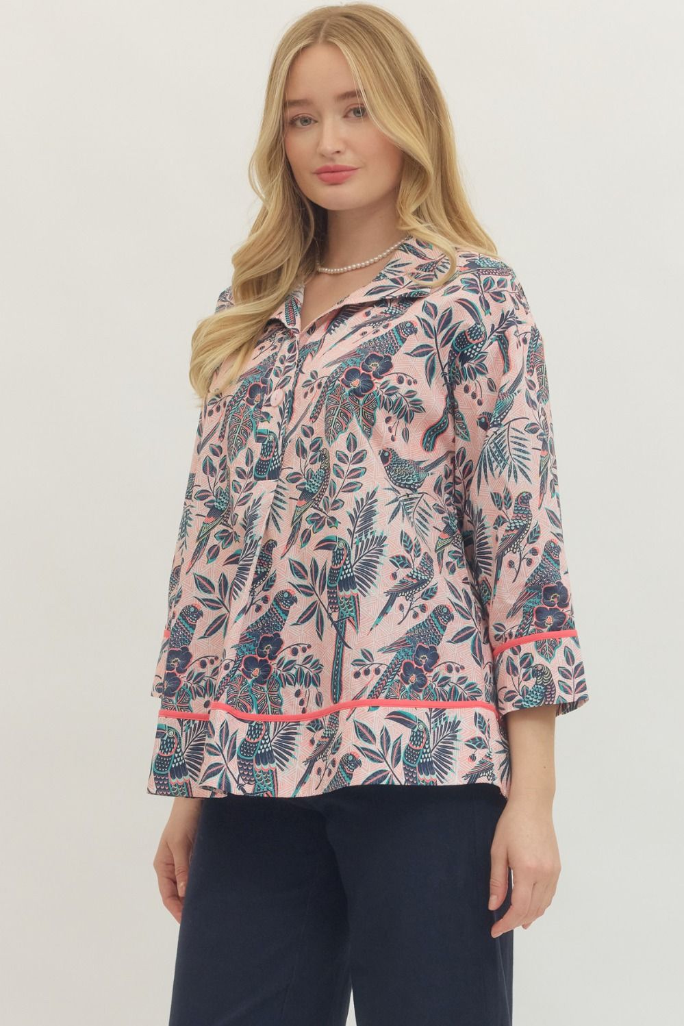 Woman wearing a floral patterned jacket on a white background