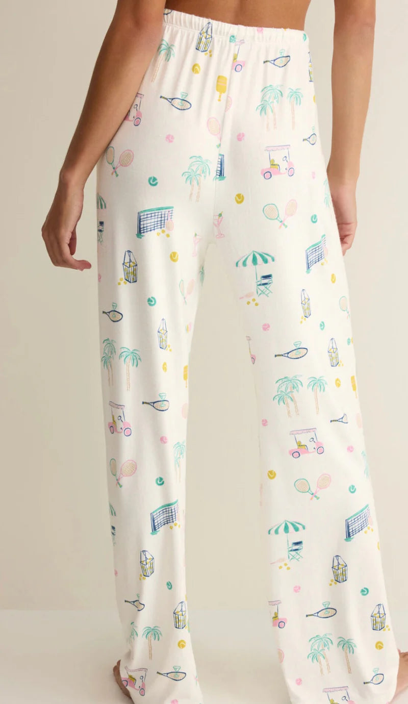 White pajama pants with colorful patterns on a neutral background