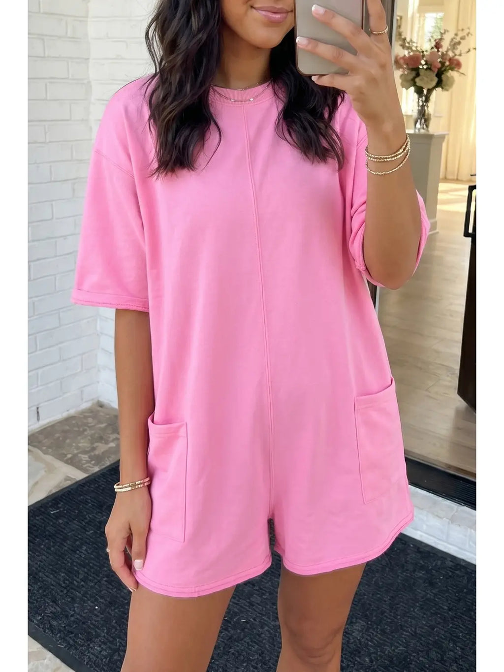 Person wearing a pink dress with shorts in an indoor setting