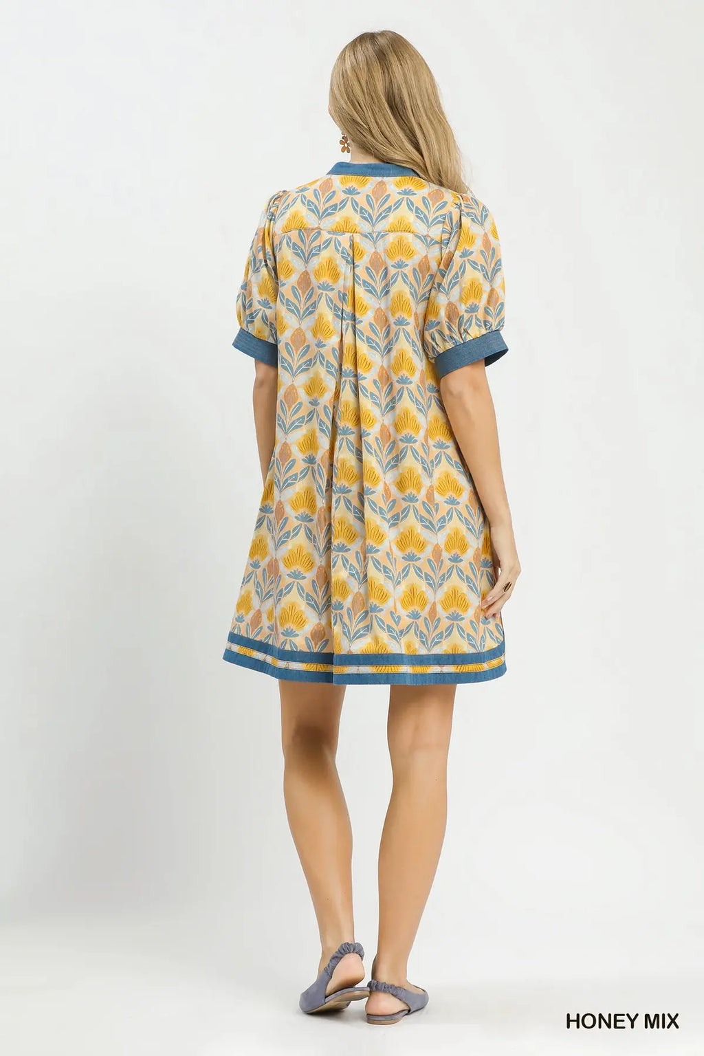 Woman wearing a patterned dress on a white background