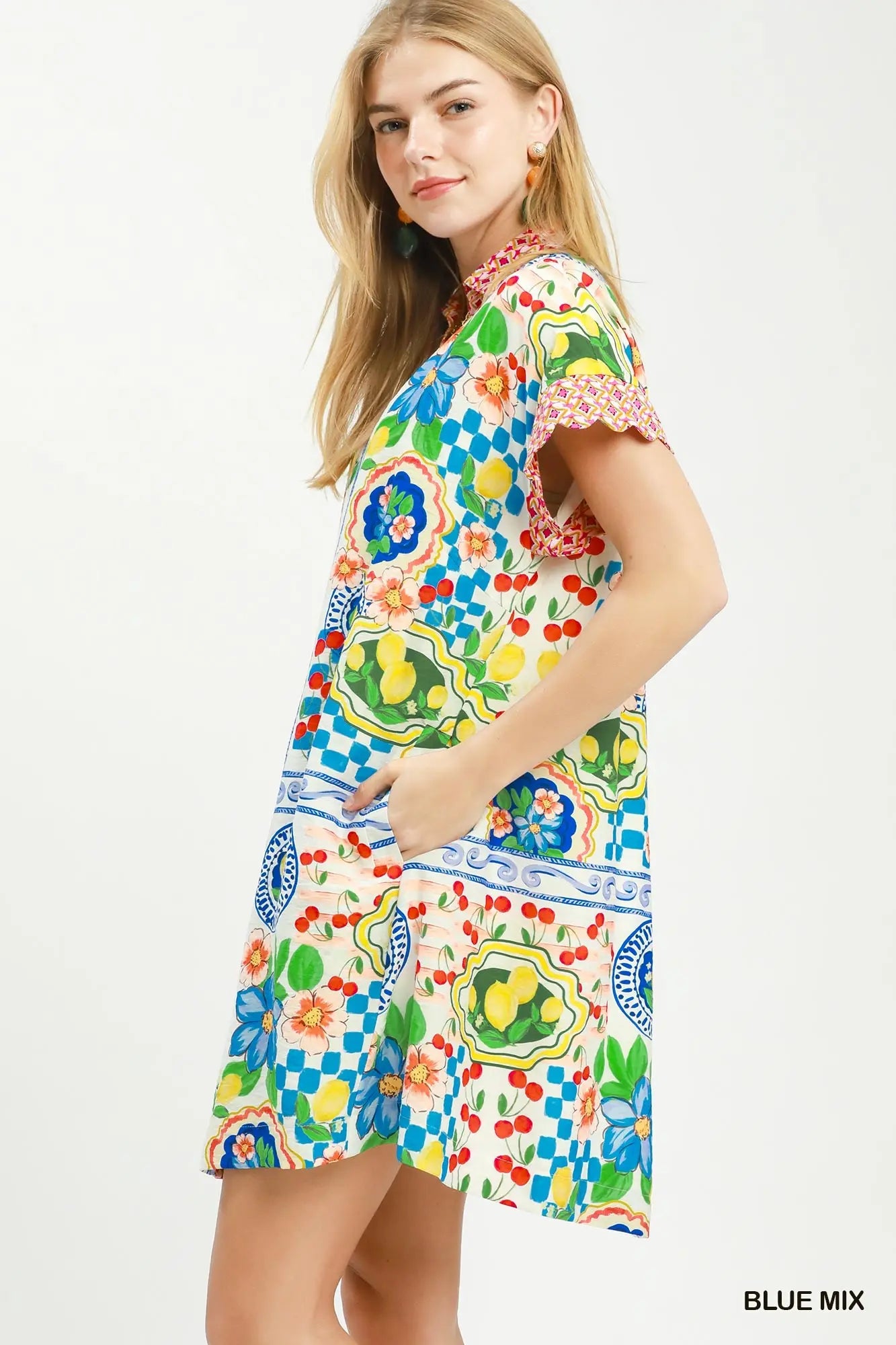 Woman wearing a colorful patterned dress on a white background