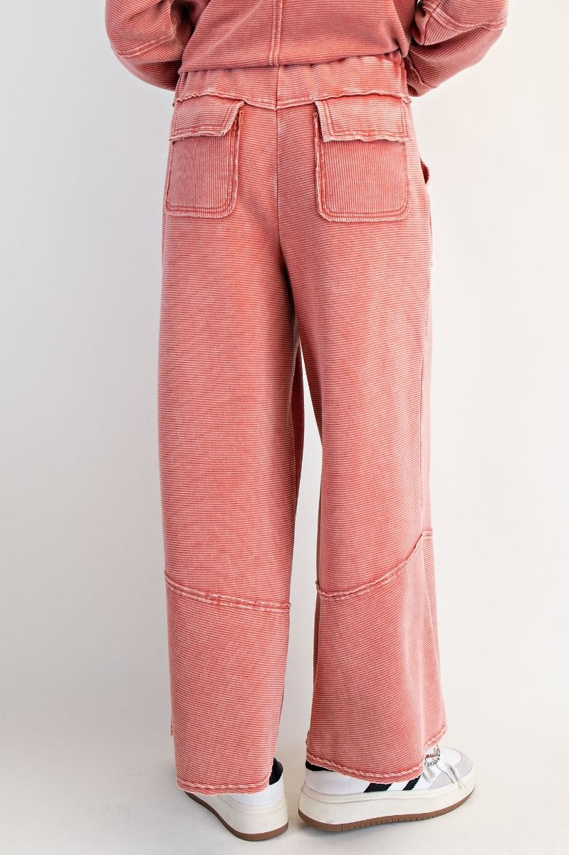 red pants worn by a person on a white background