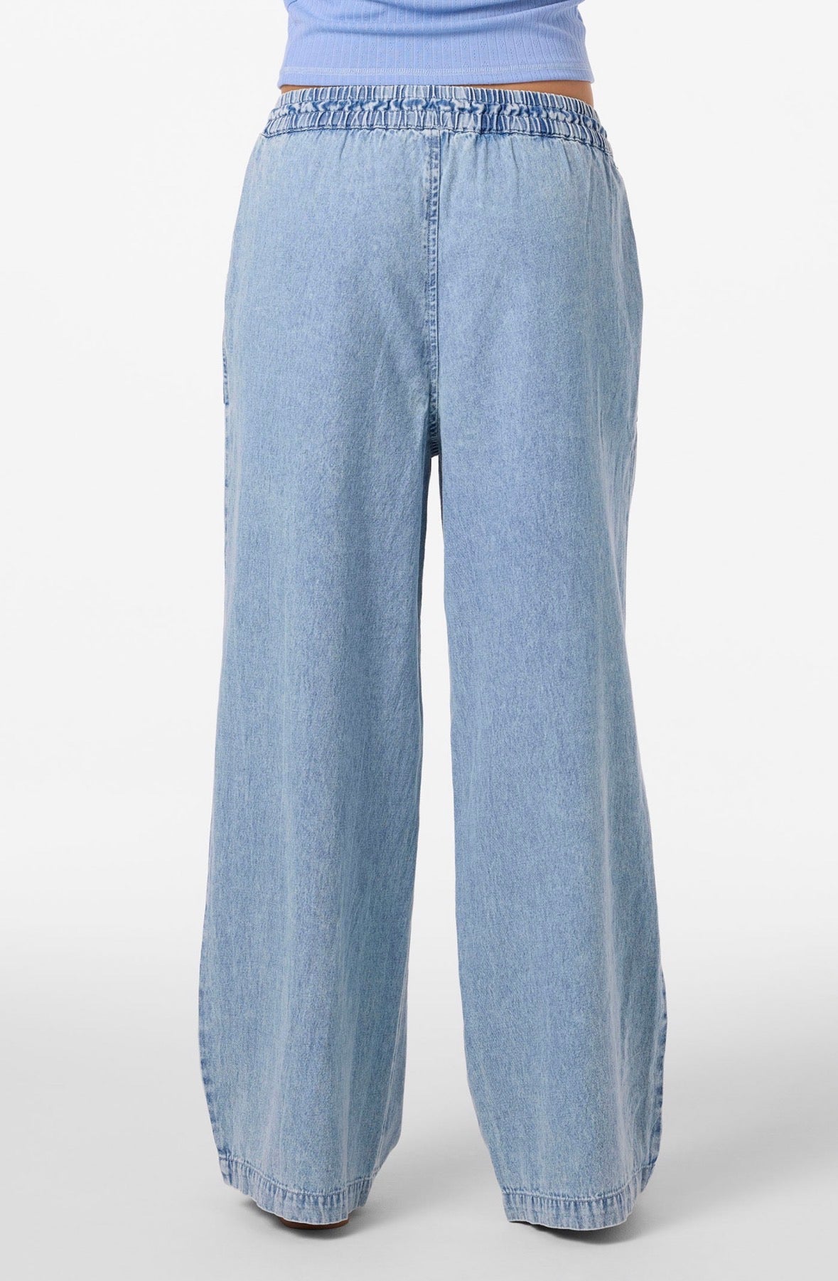 Light blue denim pants on a white background