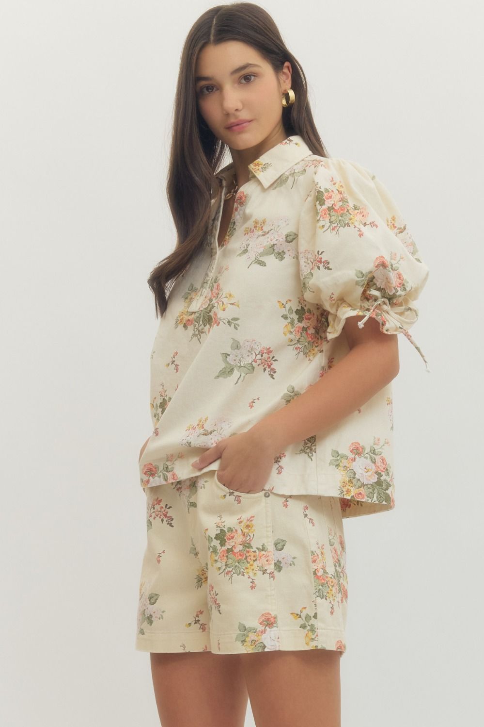 Woman wearing a floral outfit on a white background