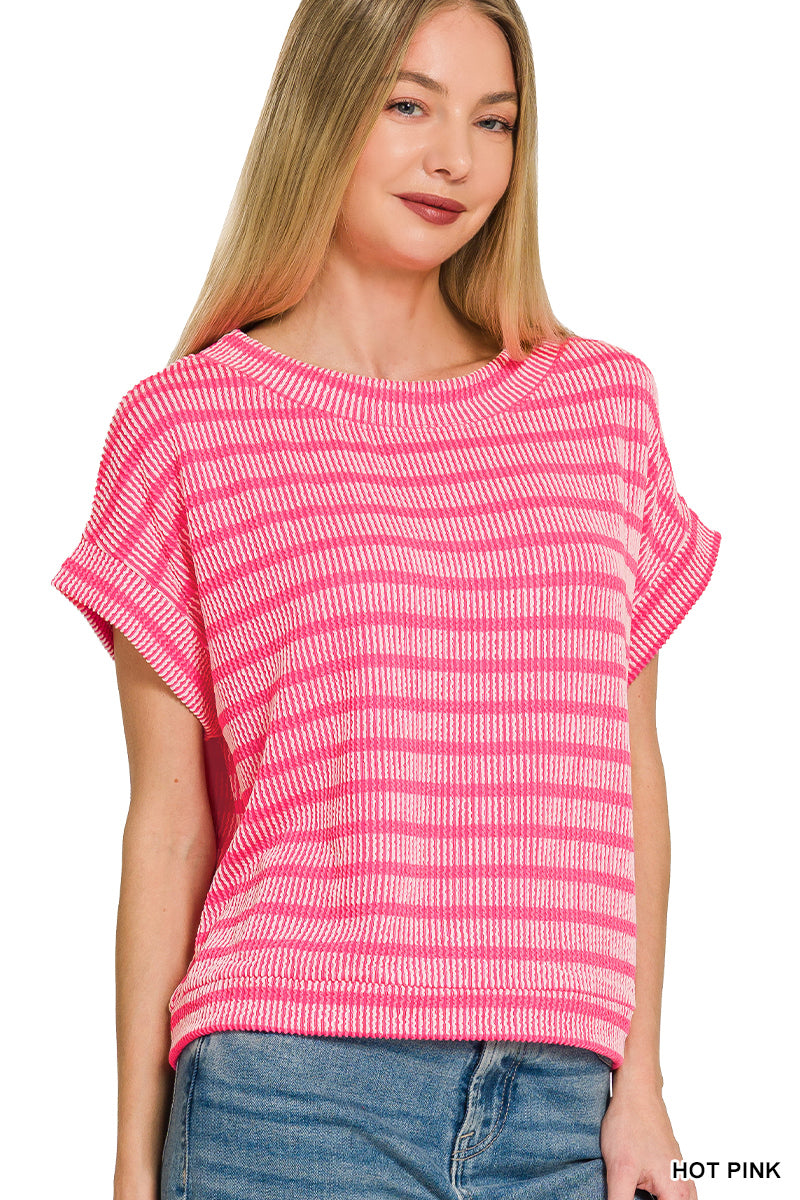 Woman wearing a pink and white striped shirt with blue jeans on a white background