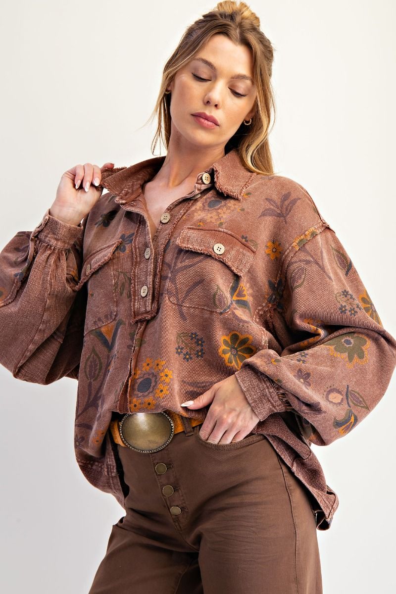 Woman wearing a brown patterned jacket and pants on a white background