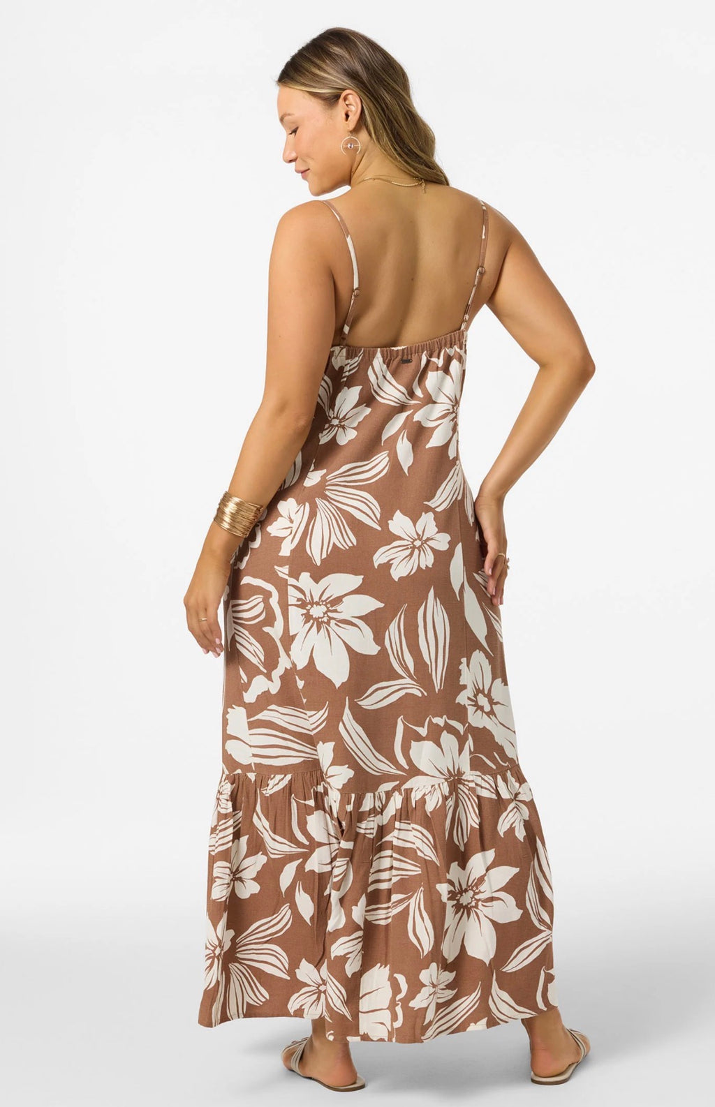 Woman wearing a brown floral maxi dress on a white background