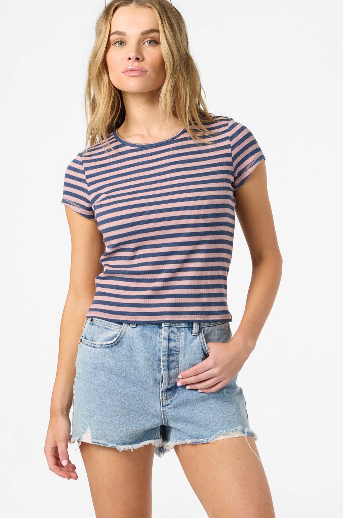 Woman wearing a striped t-shirt and denim shorts on a white background