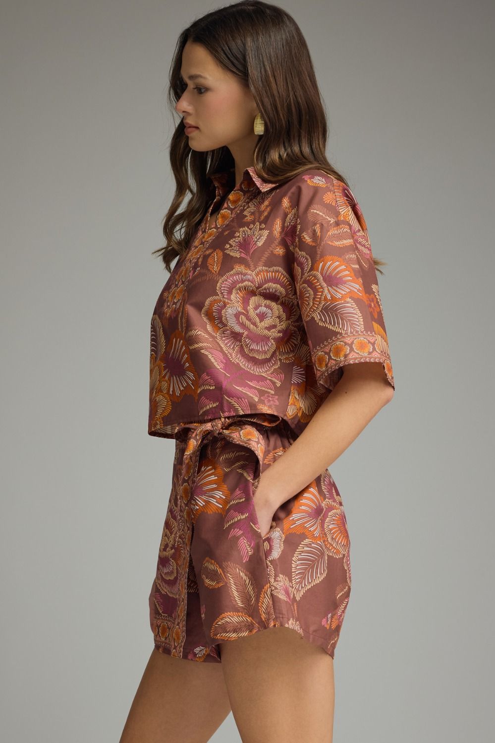 Woman wearing a patterned outfit on a plain background