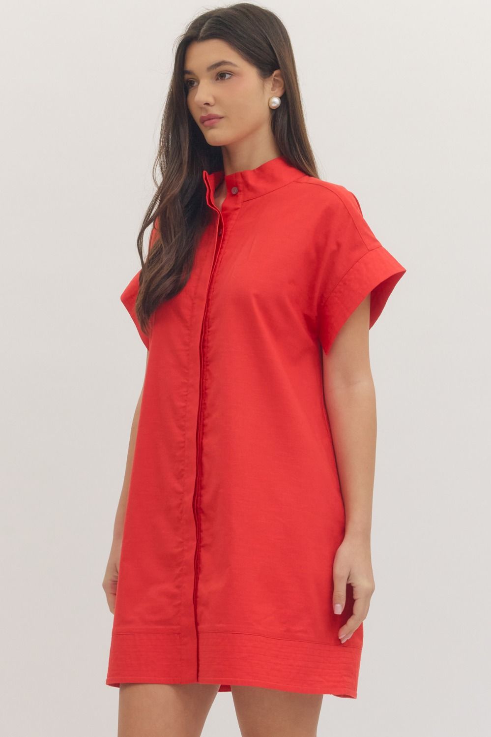 Woman wearing a red dress against a plain background